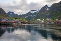 A fishing village in Lofoten islands called A/ÃÂ . Red little houses and the beautiful mountain in the bckground with soft light